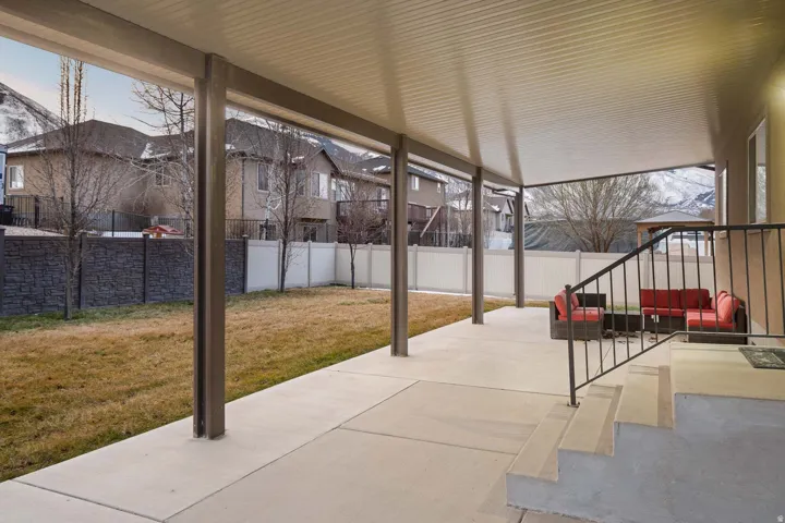 Fenced backyard with a patio and outdoor lounge area