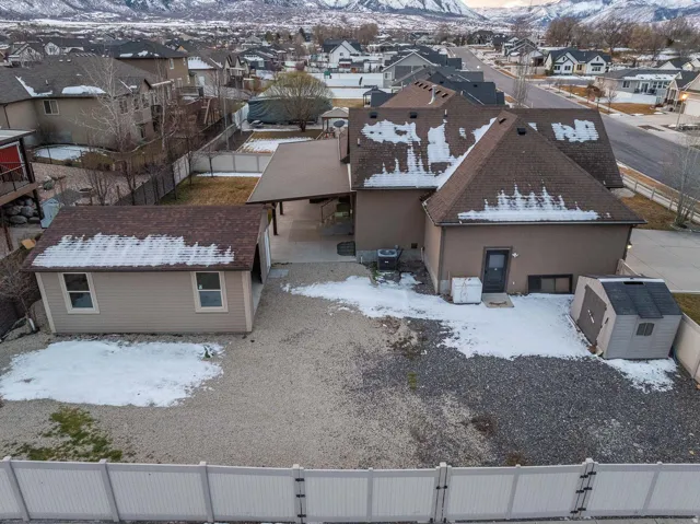 Snowy aerial view with a mountain view and a residential view