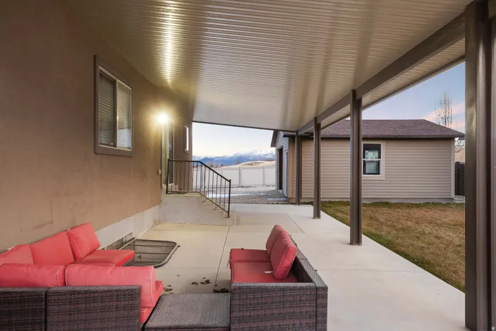 Patio terrace at dusk featuring an outdoor hangout area, a patio area, and a mountain view