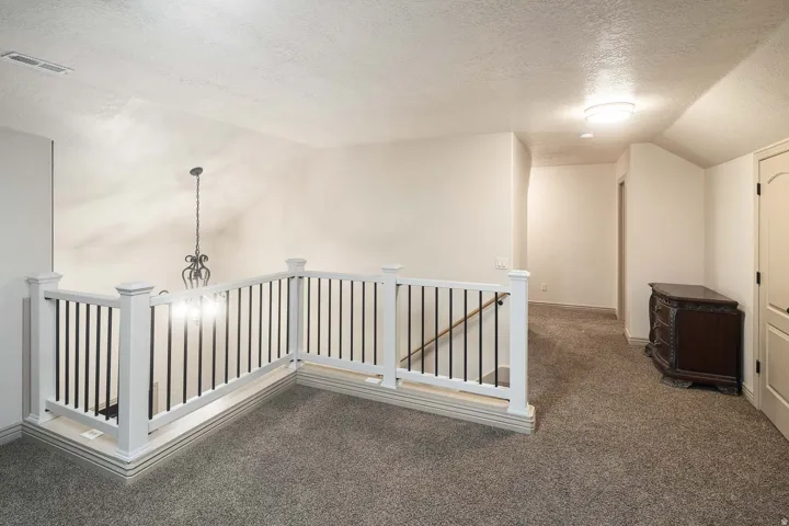 Hall with an upstairs landing and carpet