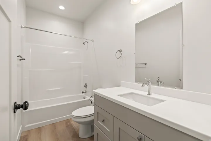 Bathroom with vanity, shower / bathtub combination, light wood-style flooring, and recessed lighting