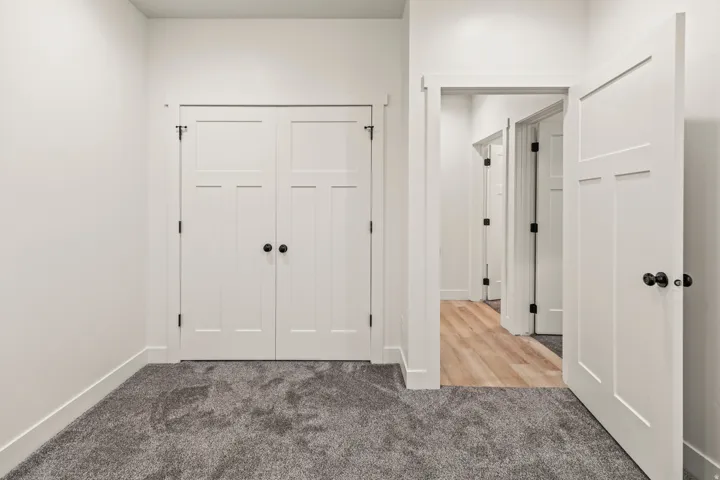Corridor featuring carpet floors and baseboards