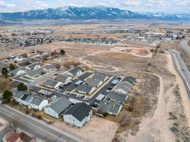Aerial overview of property's location with nearby suburban area and a mountain backdrop