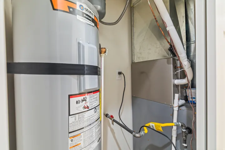 Utility room with water heater and heating unit