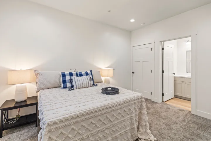 Bedroom with light carpet, a closet, recessed lighting, and ensuite bathroom