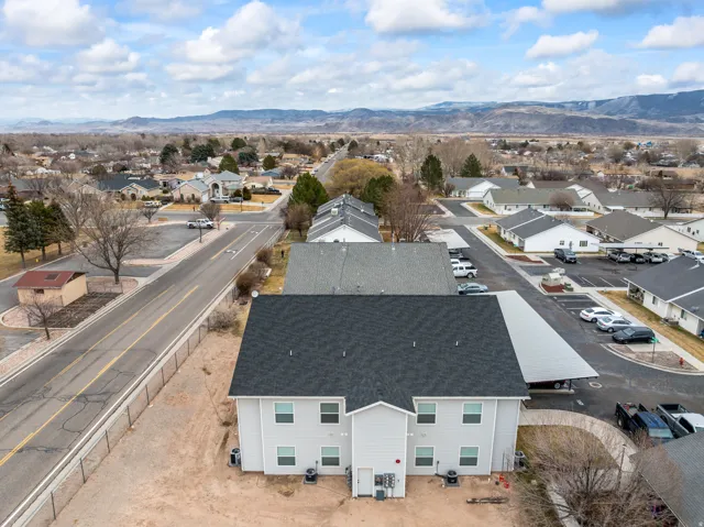 Aerial perspective of suburban area with a mountainous background