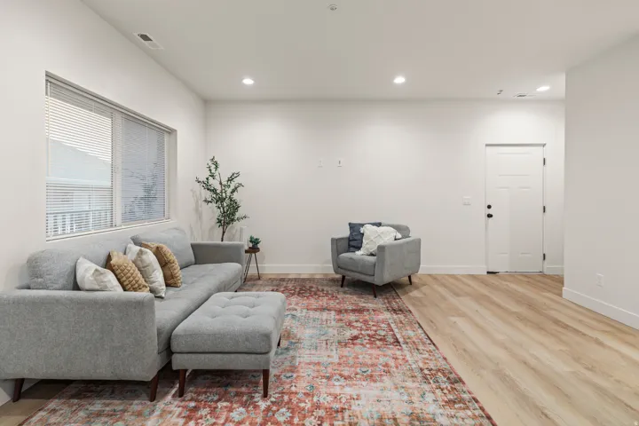 Living area with recessed lighting and light wood-style floors