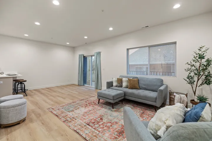 Living room featuring light wood finished floors and recessed lighting