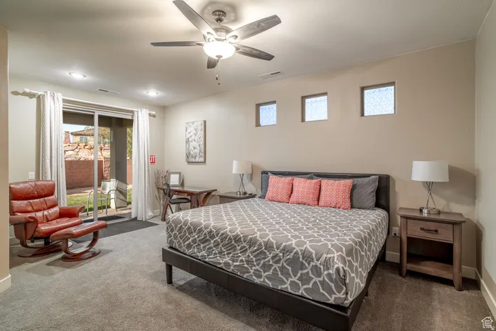 Bedroom with access to exterior, carpet, and ceiling fan