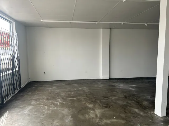 Unfurnished room featuring unfinished concrete floors