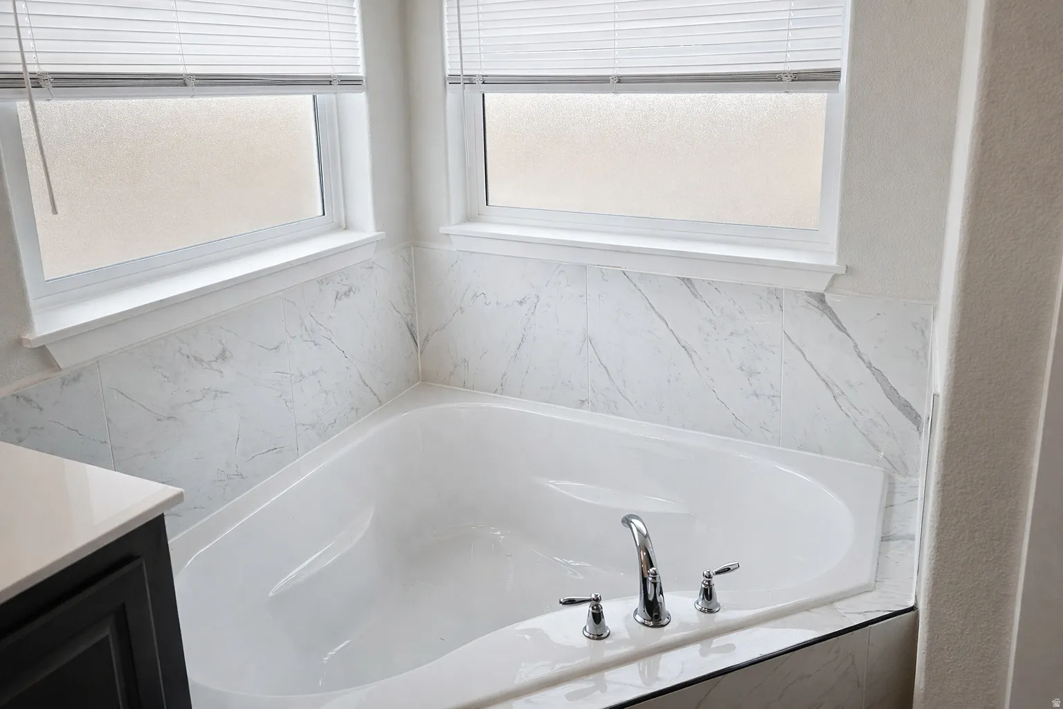 Full bathroom with a garden tub and vanity