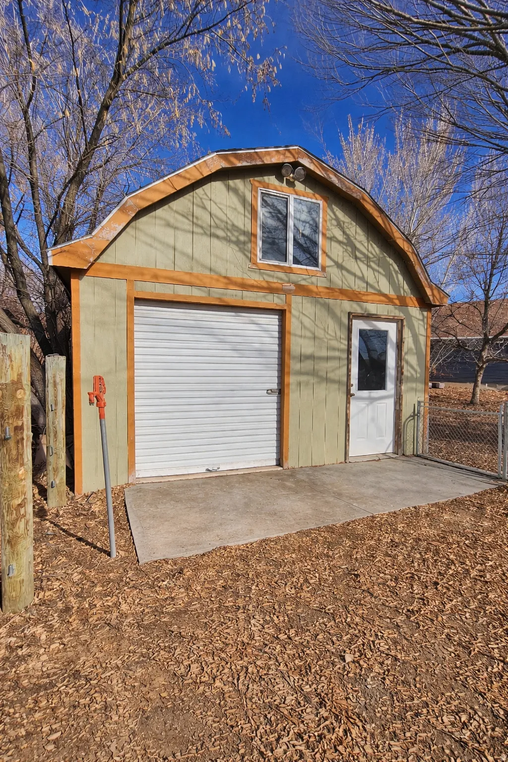 View of storage shed  with small garage door