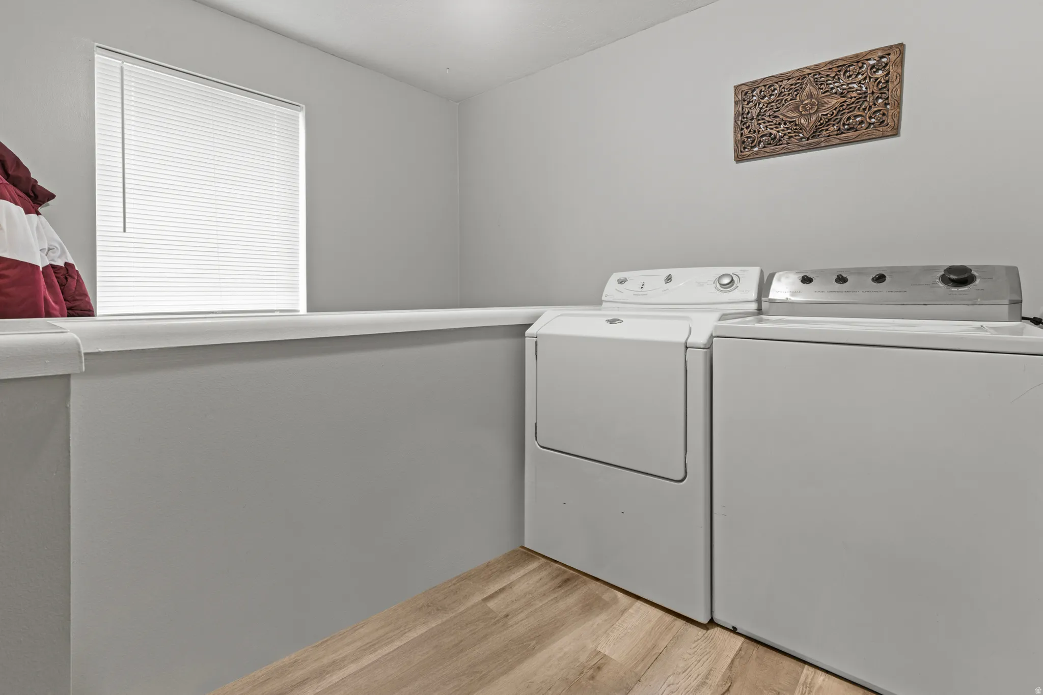 Laundry area featuring light wood-style floors and independent washer and dryer