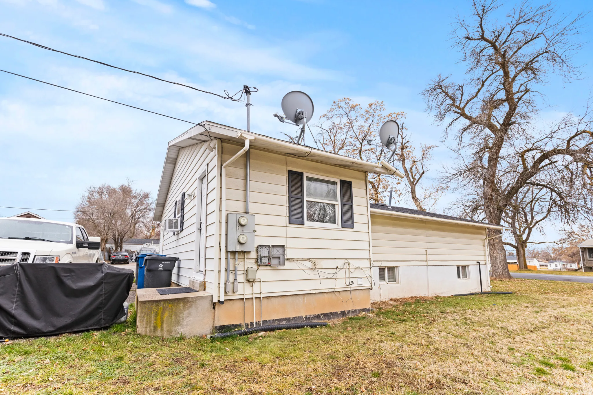 View of side of home featuring a yard