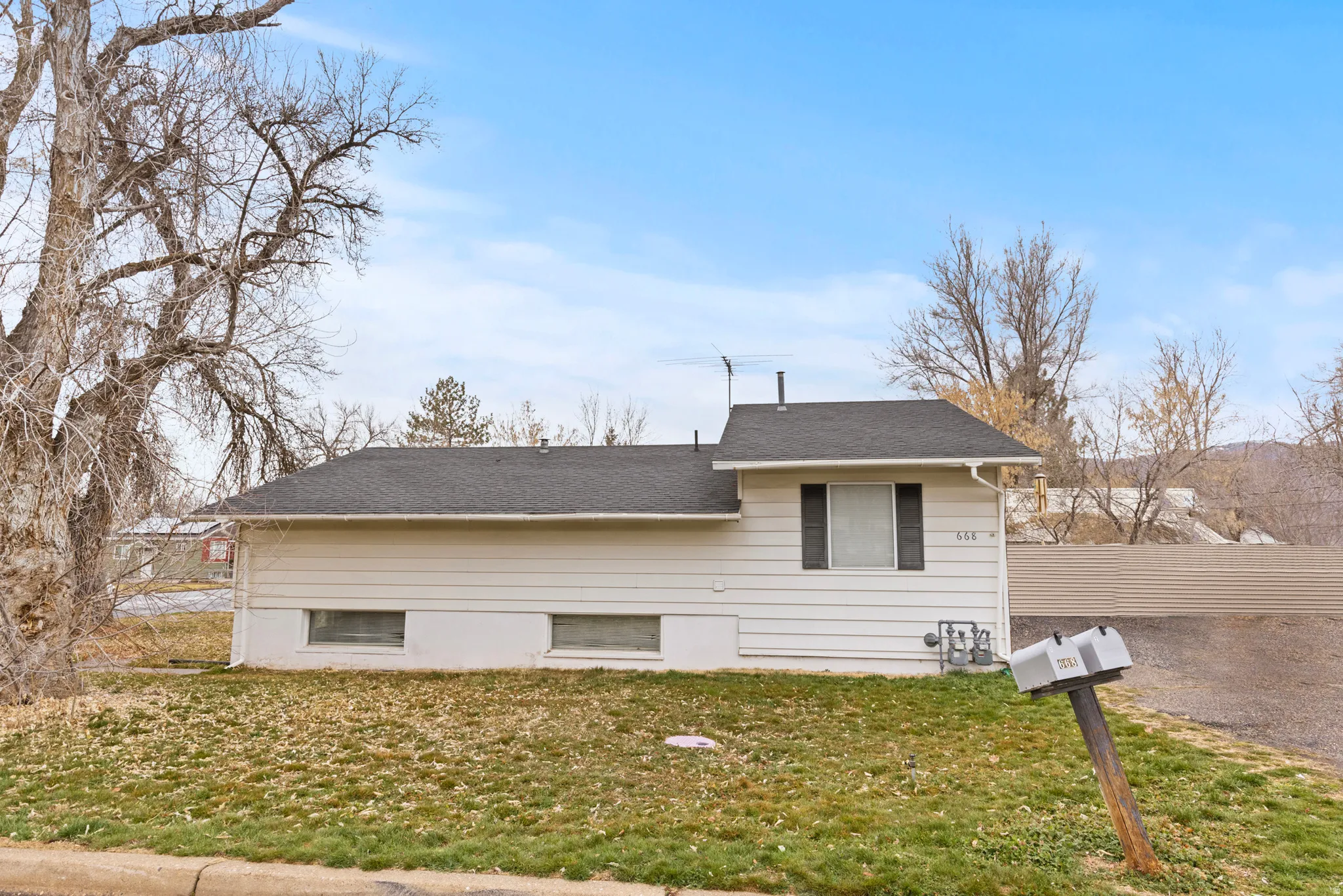View of front of house featuring a shingled roof