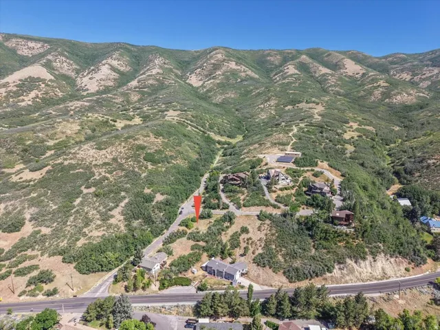 Expansive mountain landscape featuring varied terrain and a clear blue sky