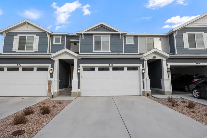 View of front of home with an attached garage and concrete driveway
