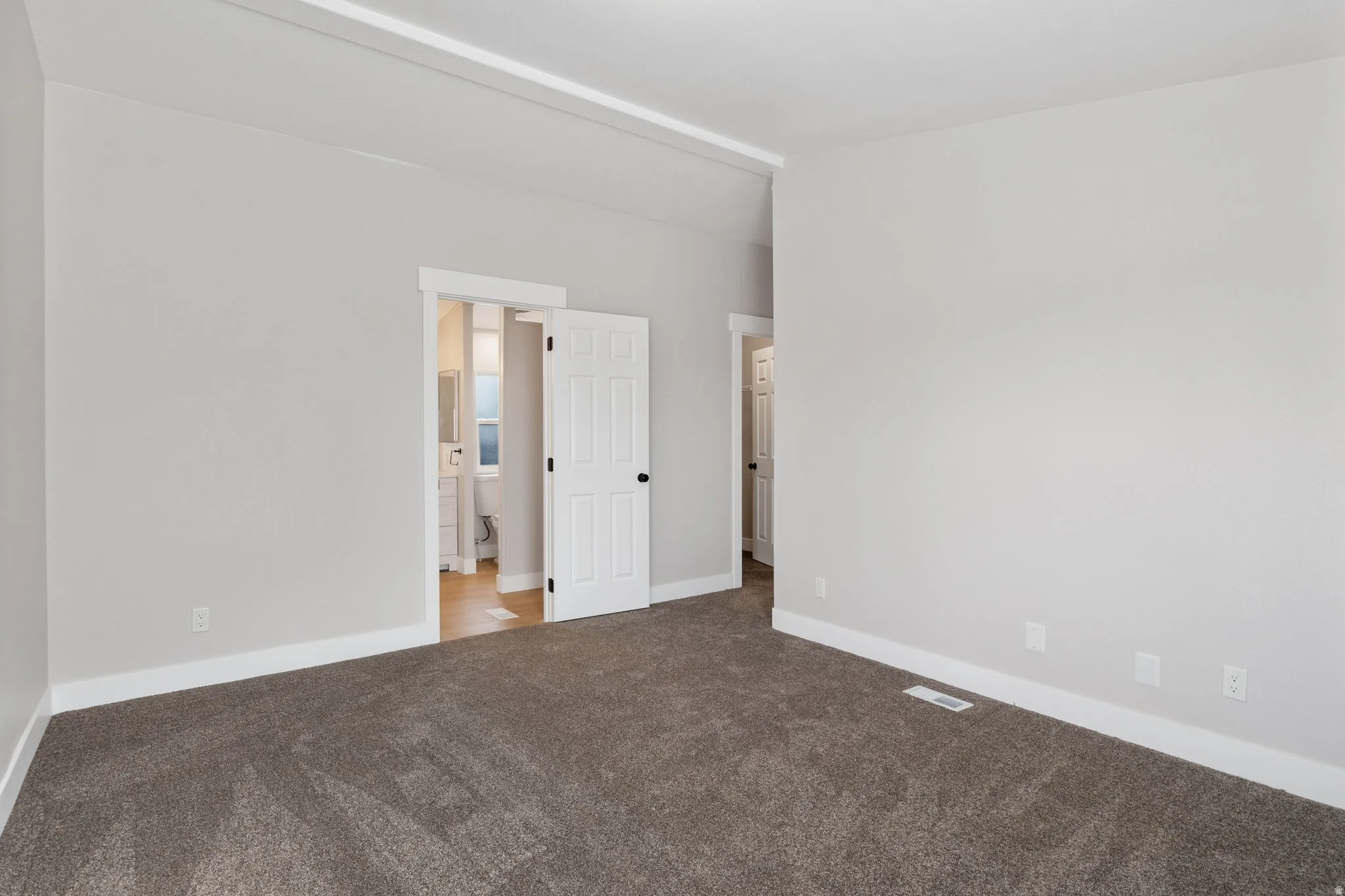 Unfurnished bedroom featuring carpet floors and baseboards