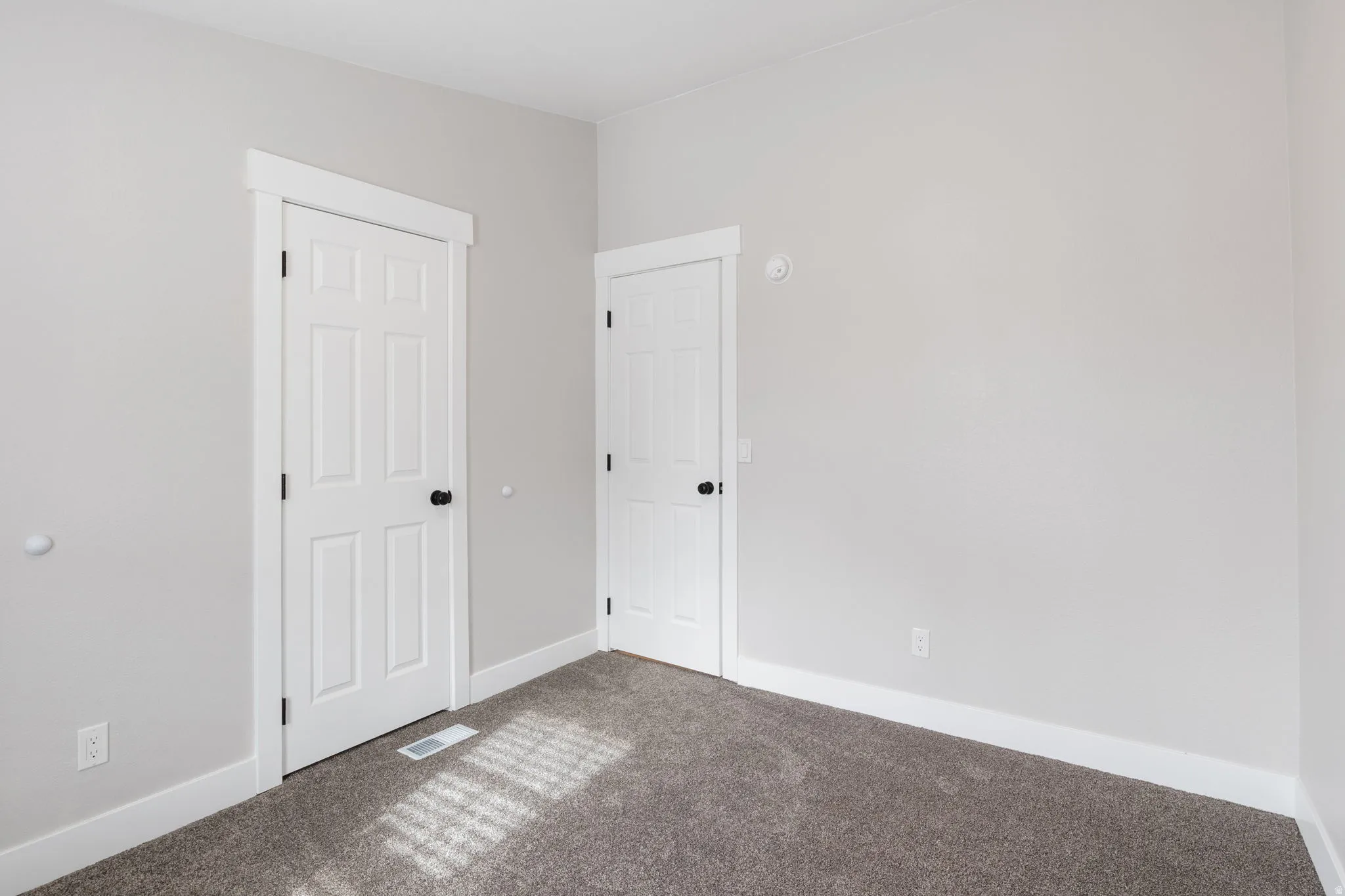 Unfurnished bedroom with carpet and baseboards