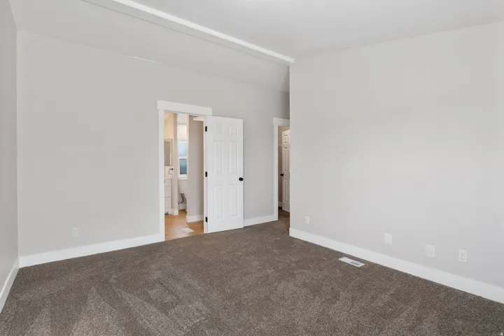 Unfurnished bedroom featuring carpet floors and baseboards