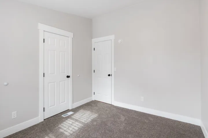Unfurnished bedroom with carpet and baseboards