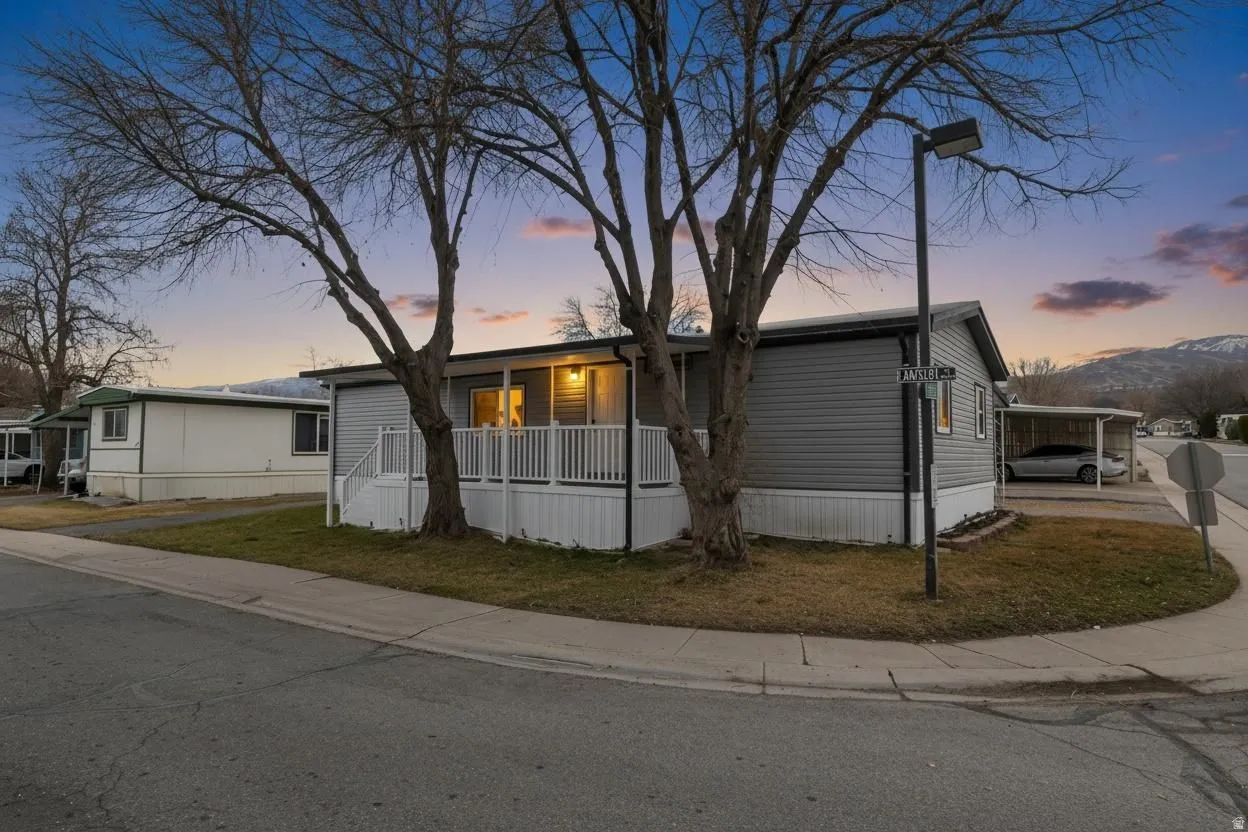 View of front of property featuring a yard and a porch
