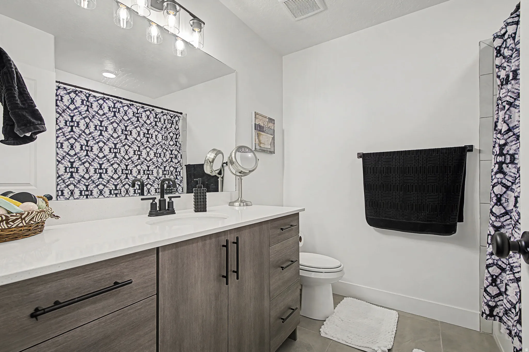 Full bathroom with vanity, and light tile patterned floors