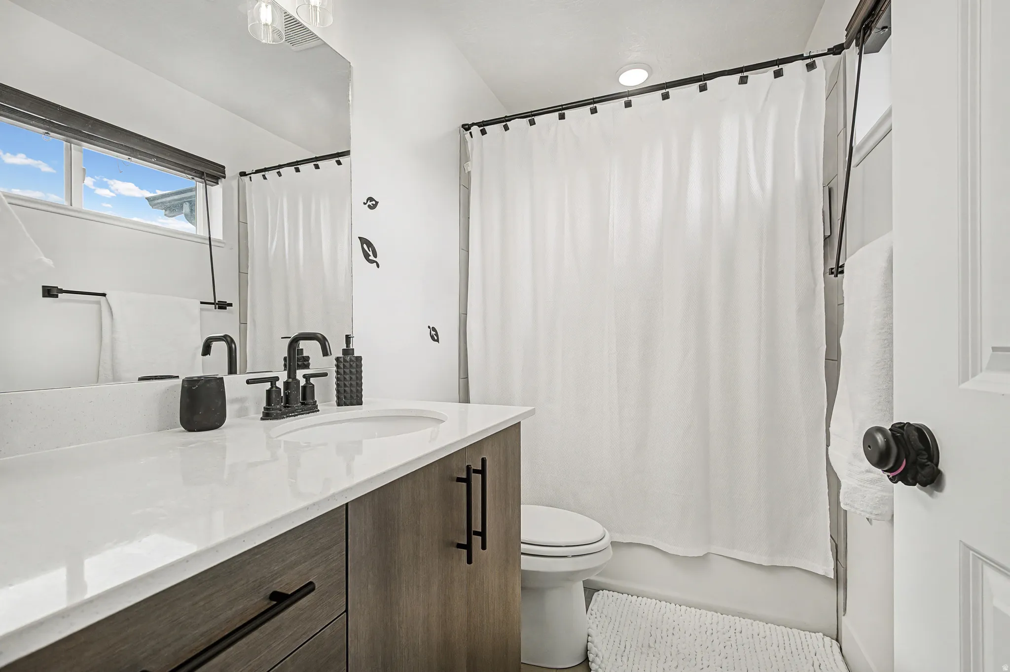 Full bathroom featuring vanity and shower / tub combo with curtain