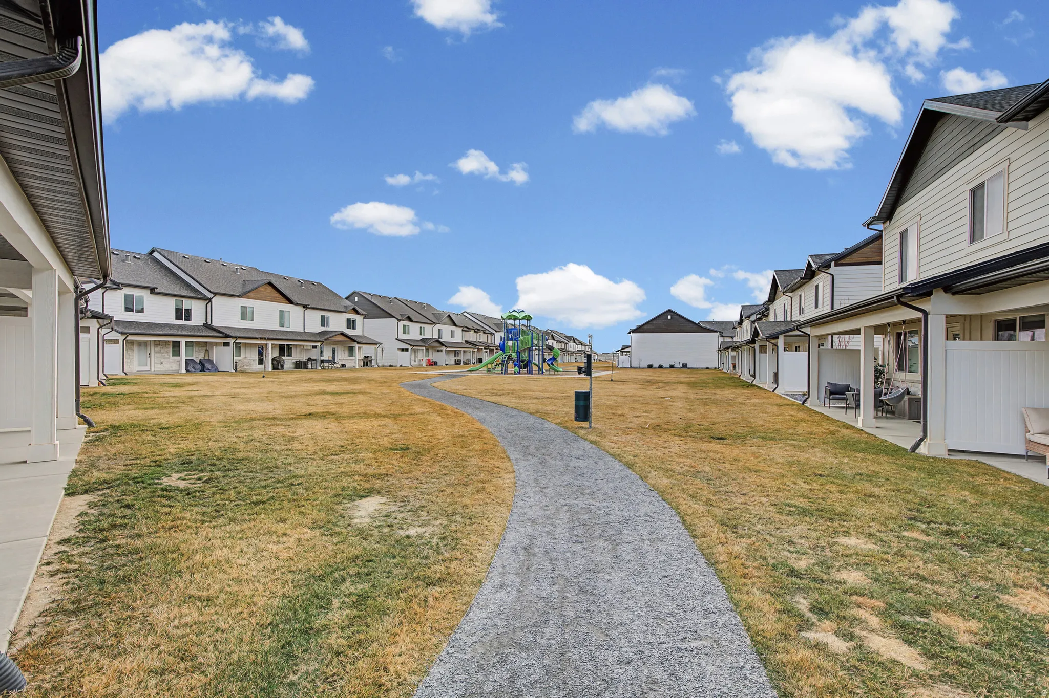View of grassy yard featuring a playground and a residential view