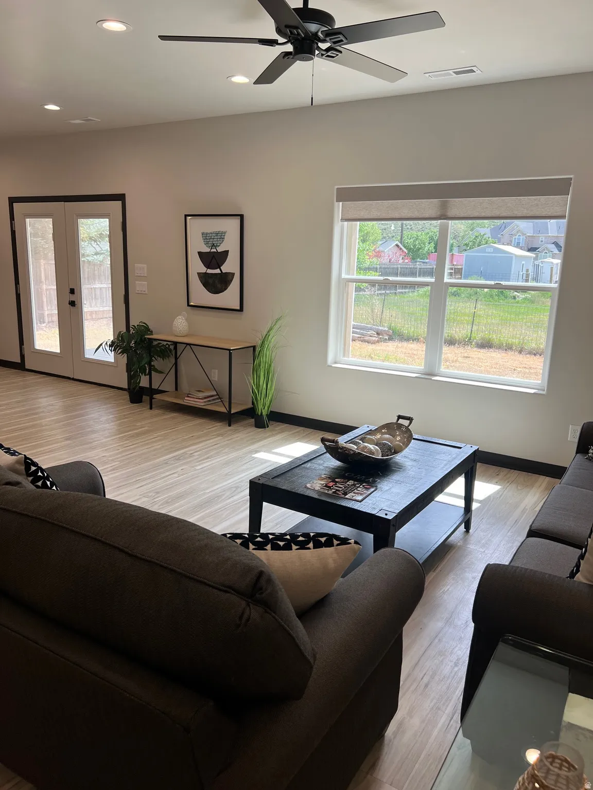 Open concept living space featuring wood-finish flooring, recessed lighting, and a ceiling fan