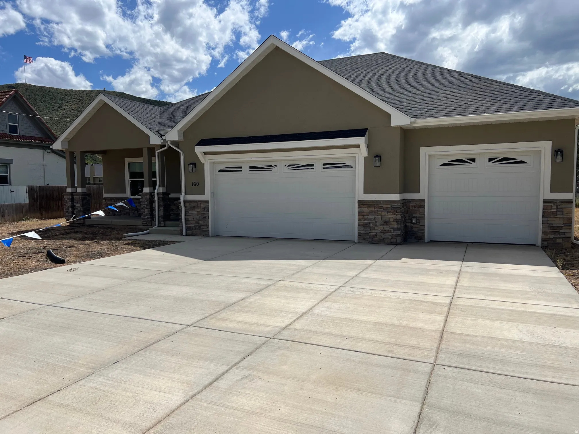 Contemporary stucco exterior with a stone veneer accent