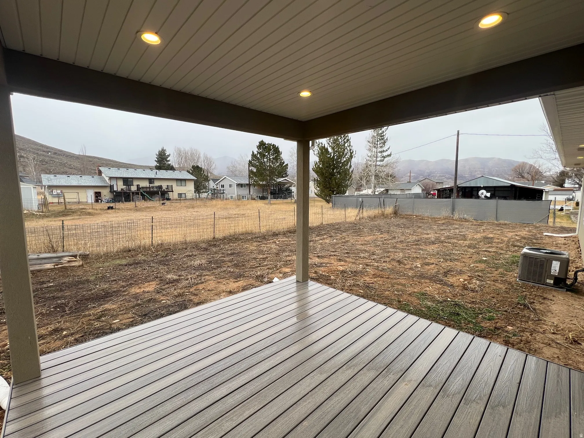 Wooden deck with a residential view and a fenced backyard