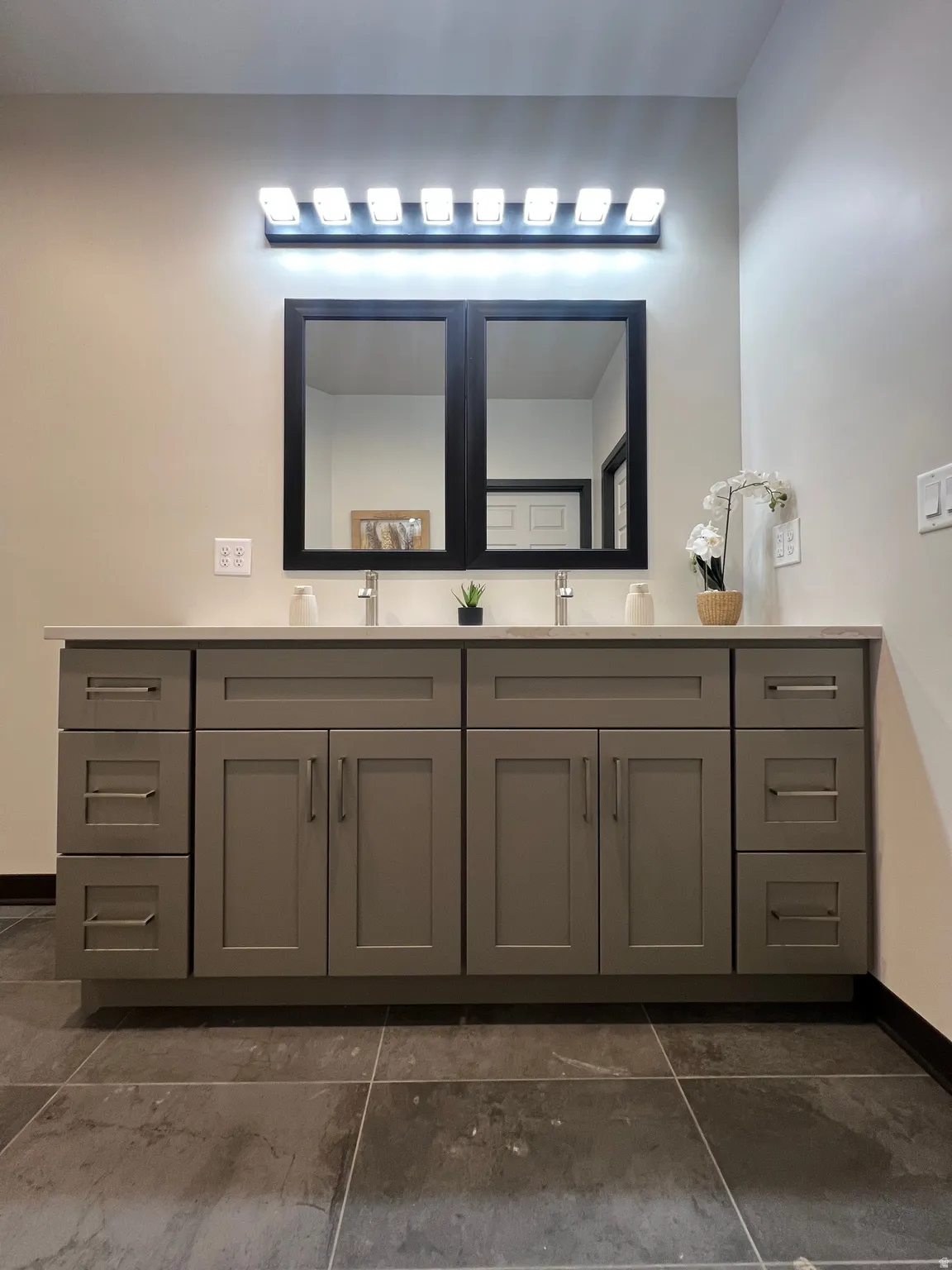 Dual vanity with light gray shaker cabinetry, brushed nickel hardware, and a white countertop