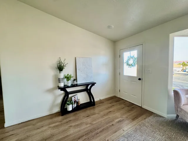 Entrance foyer with wood finished floors and baseboards