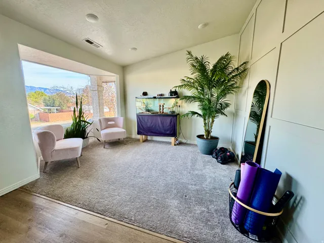 Living area featuring a textured ceiling and wood finished accent wall