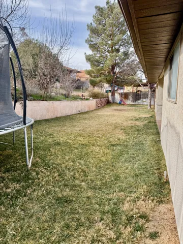 Fenced backyard with a trampoline