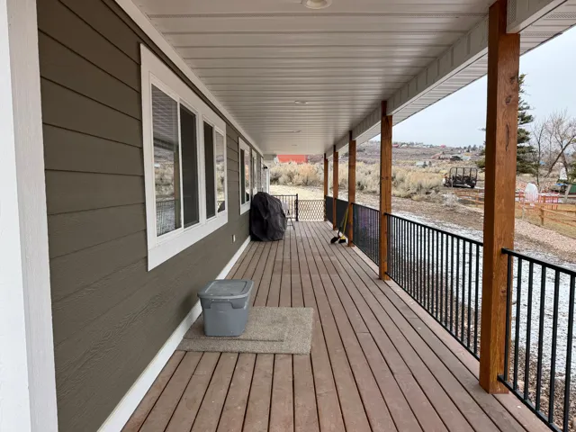 Wooden porch featuring area for grilling