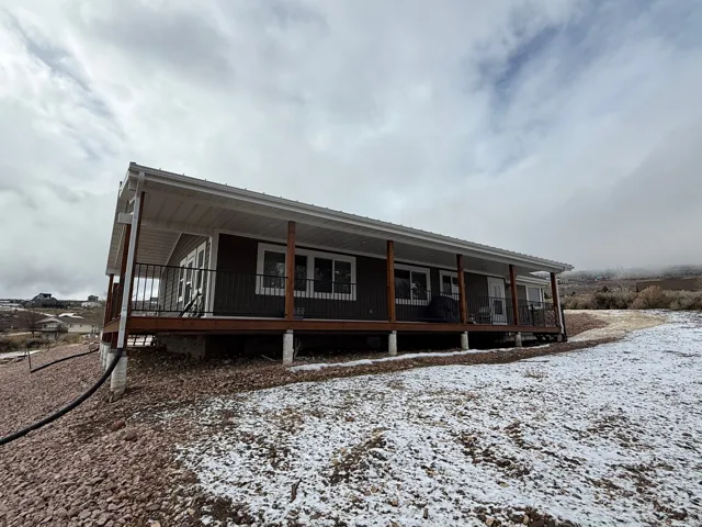 Rear view of house featuring a porch