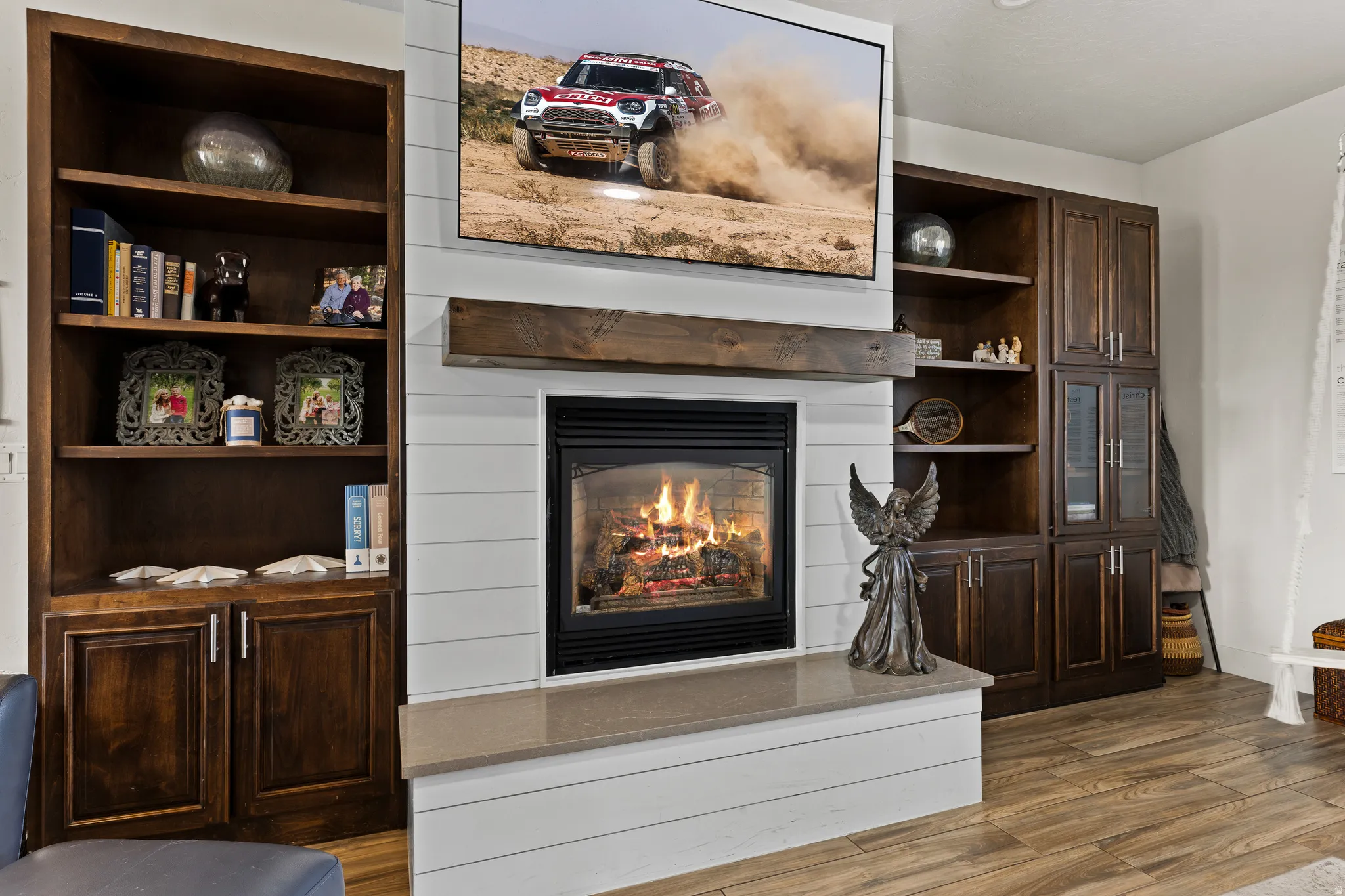 Detailed view of a glass covered fireplace and wood finished floors