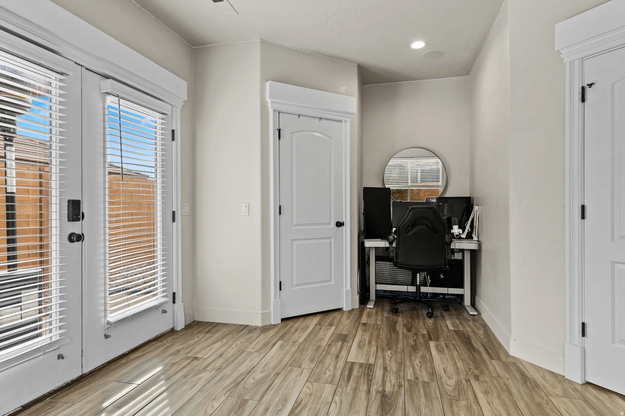 Office featuring light wood finished floors and french doors