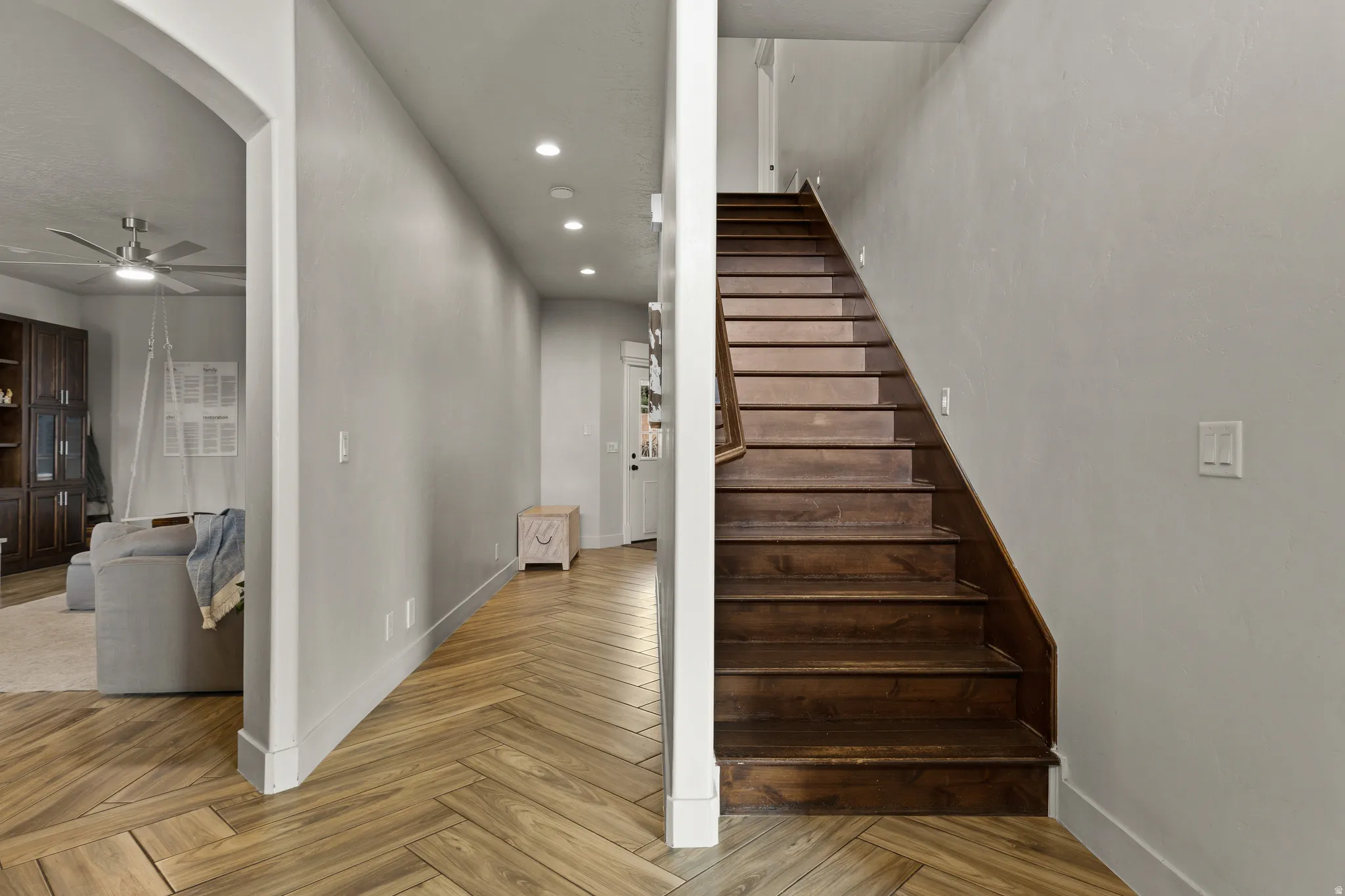 Stairway with parquet flooring, ceiling fan, and recessed lighting