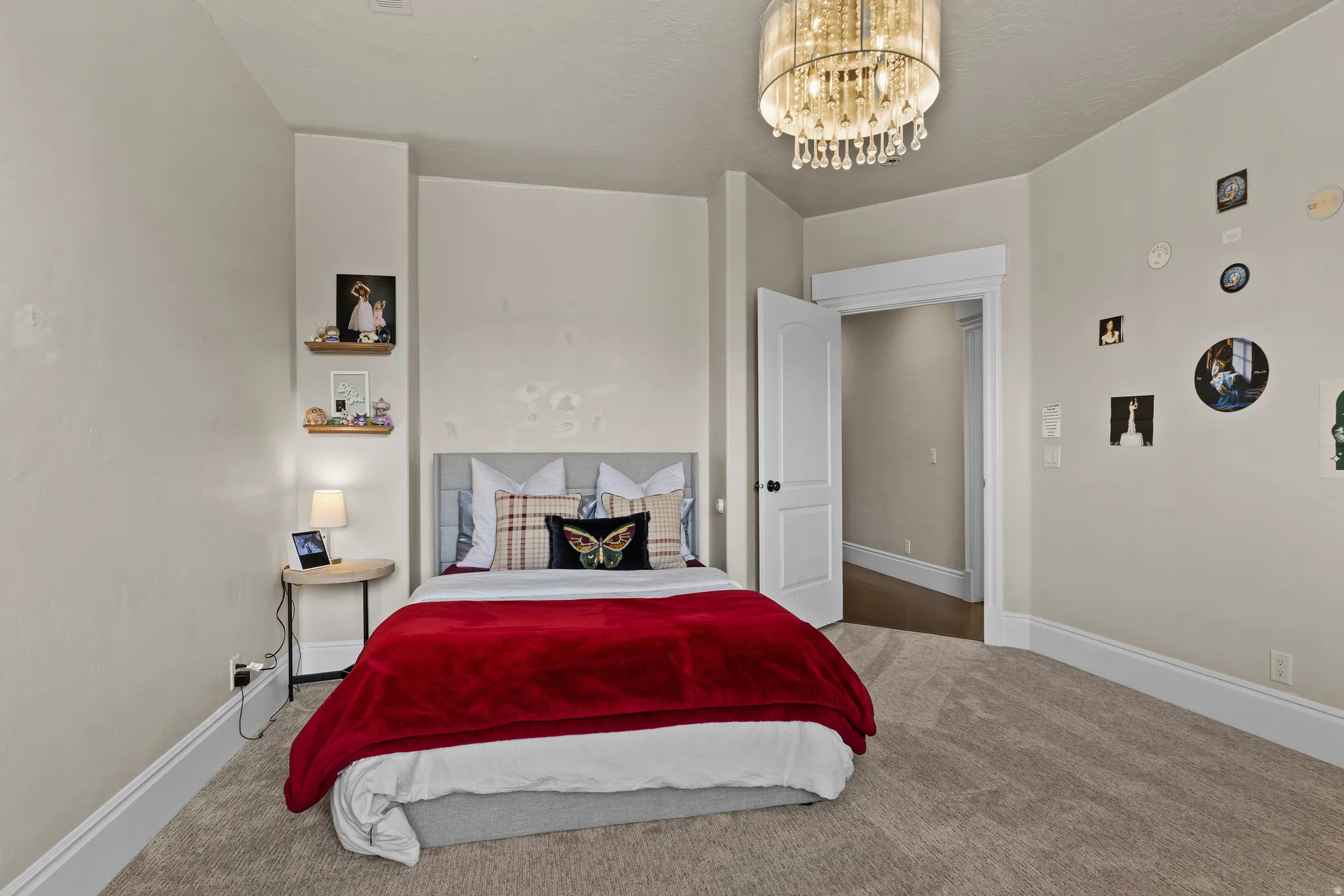 Carpeted bedroom featuring suspended lighting and baseboards