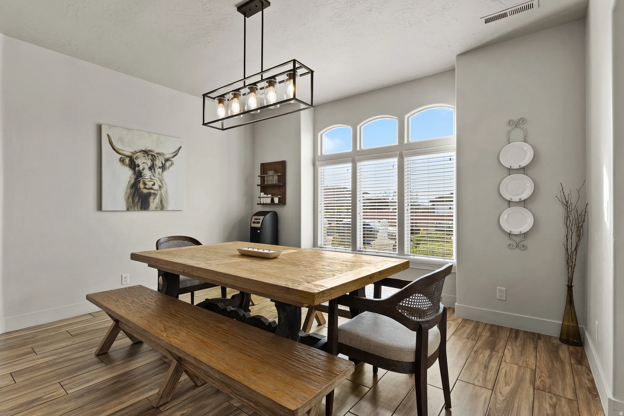 Dining area with wood finish floors and a textured ceiling