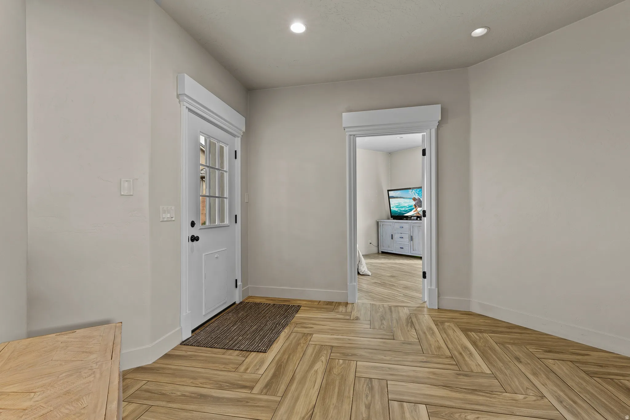 Foyer entrance featuring parquet flooring, recessed lighting, and healthy amount of natural light