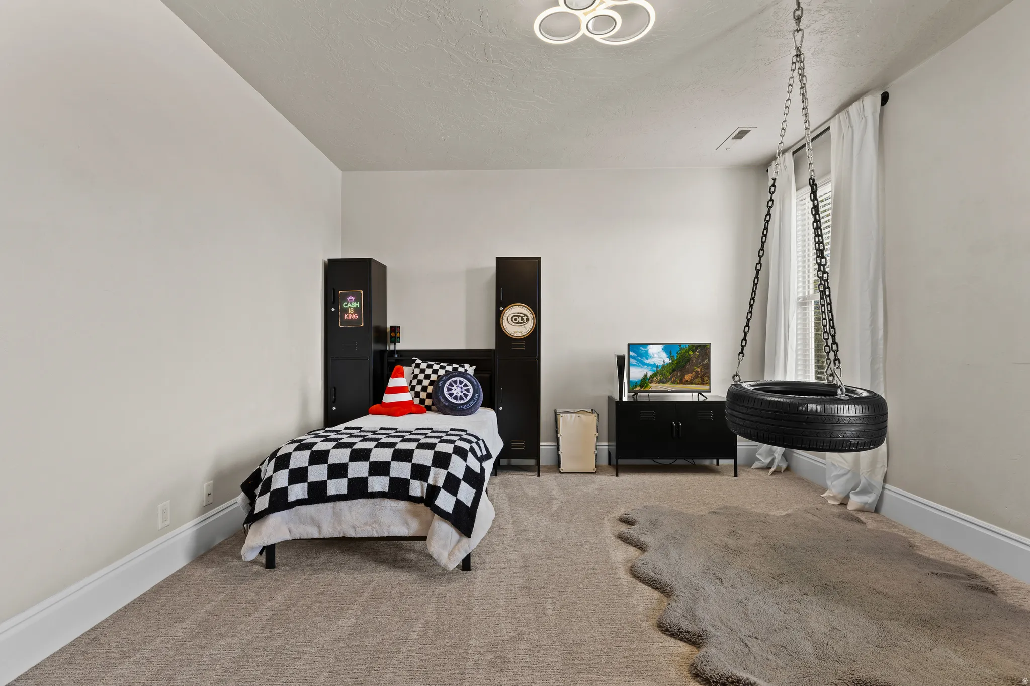 Carpeted bedroom featuring baseboards and a textured ceiling