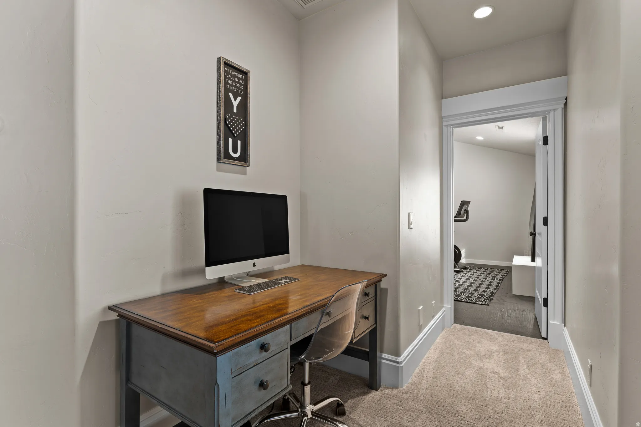 Office space with recessed lighting and carpet floors