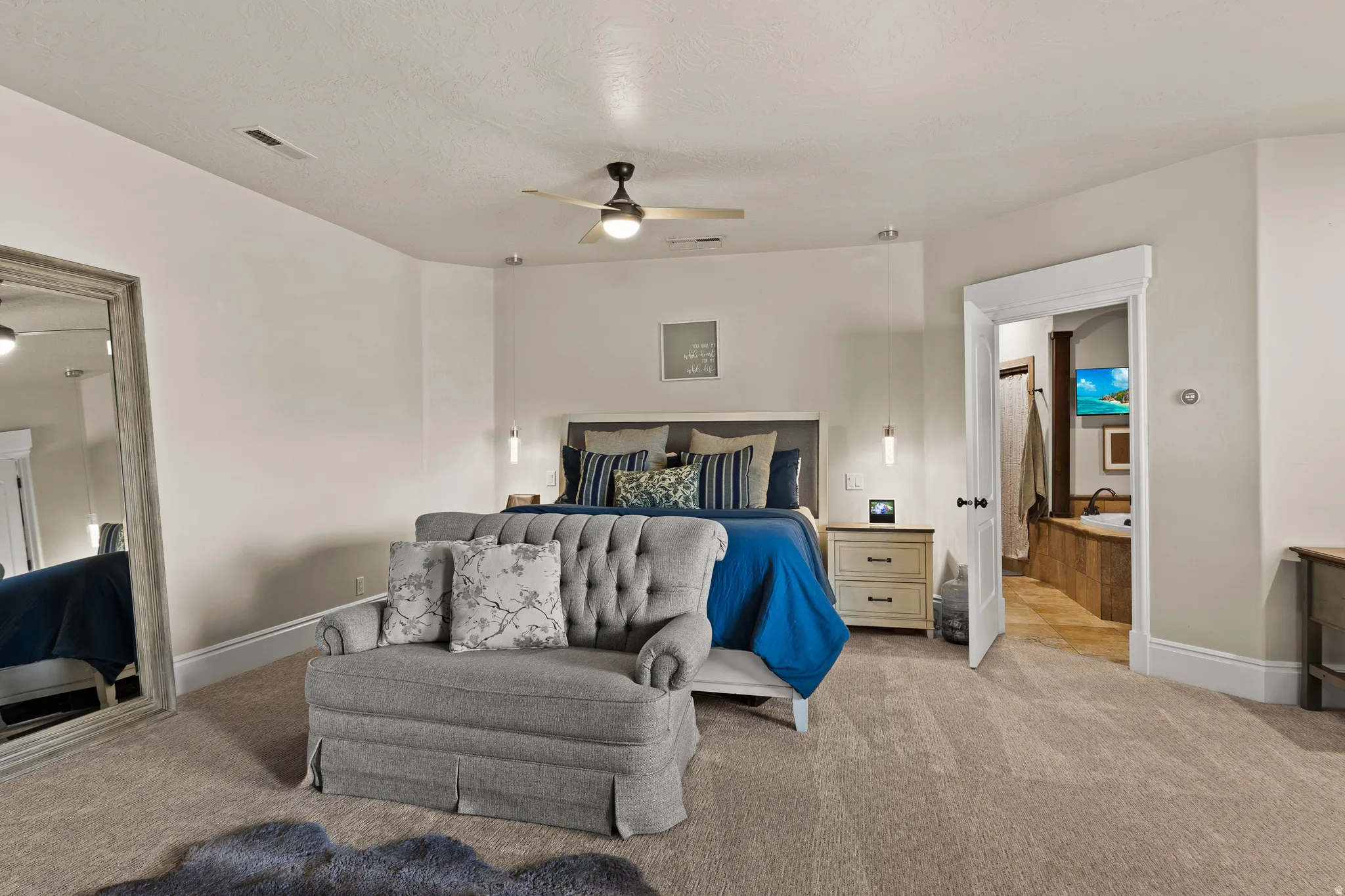 Carpeted bedroom featuring baseboards and a ceiling fan