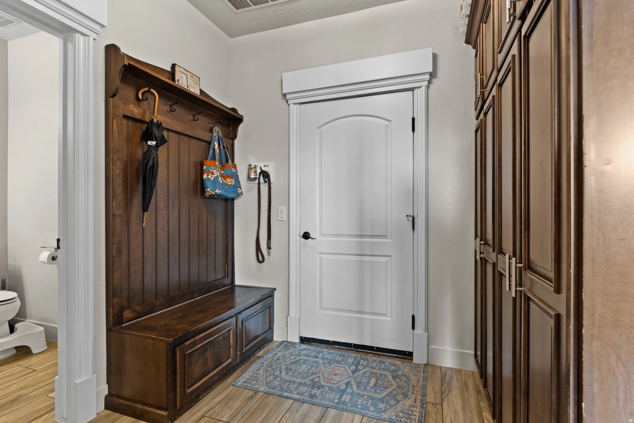 Mudroom featuring light wood-style flooring and baseboards