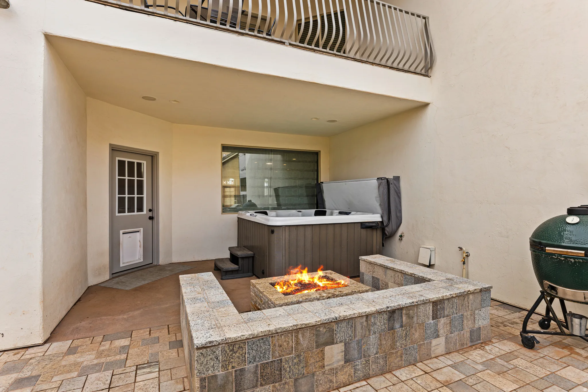 View of patio with a fire pit