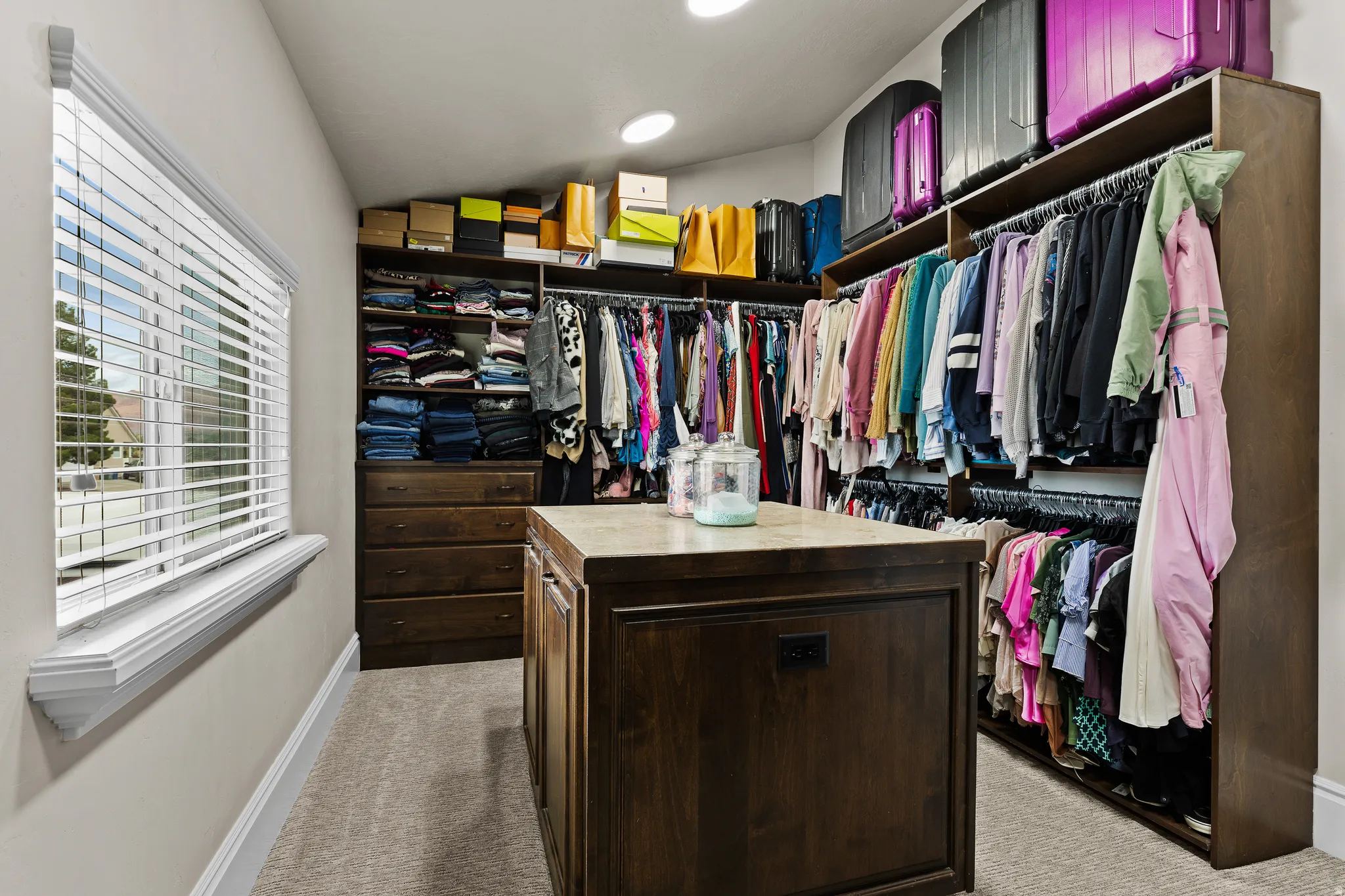Walk in closet with carpet flooring and vaulted ceiling